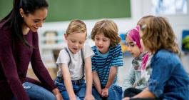 students reading with teacher