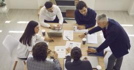 people at desk collaborating 