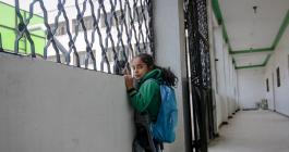 Little girl looking out a window